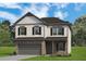 Charming two-story home featuring a two-car garage, brick accents, and symmetrical window placement at 321 Silver Leaf Trce, Douglasville, GA 30134