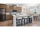 Modern kitchen with island and seating adjoins dining area and stainless appliances at 321 Silver Leaf Trce, Douglasville, GA 30134