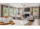 Stylish living room, showcasing fireplace, contemporary furniture, and open flow from adjacent kitchen area at 321 Silver Leaf Trce, Douglasville, GA 30134