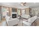 Bright living room showcasing a fireplace, neutral tones, and lots of natural light from multiple windows at 321 Silver Leaf Trce, Douglasville, GA 30134