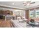 Open-concept living room adjacent to the kitchen and dining area with ample seating and natural light at 321 Silver Leaf Trce, Douglasville, GA 30134