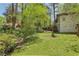 Expansive backyard with mature trees, lush lawn, and quaint deck, perfect for outdoor enjoyment at 952 Columbia Dr, Decatur, GA 30030