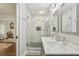 Bathroom featuring double sinks, gray cabinetry, modern fixtures, and glass door shower with marble tile at 952 Columbia Dr, Decatur, GA 30030