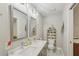 Bathroom with double sinks, white marble floors, modern vanity, and ample counter space at 952 Columbia Dr, Decatur, GA 30030