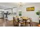 Open-concept dining room featuring modern lighting, stylish furniture, and hardwood floors at 952 Columbia Dr, Decatur, GA 30030