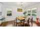 Inviting dining room featuring natural light, modern light fixture, and hardwood floors at 952 Columbia Dr, Decatur, GA 30030