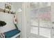 Bright entryway featuring a decorative glass door, built-in bench, and convenient storage hooks at 952 Columbia Dr, Decatur, GA 30030