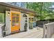 Cozy front porch featuring an eye-catching orange front door and stylish outdoor decor at 952 Columbia Dr, Decatur, GA 30030