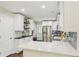 Updated kitchen boasts white cabinets, stainless steel appliances, quartz countertops, and modern fixtures at 952 Columbia Dr, Decatur, GA 30030