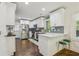 Bright kitchen features white cabinetry, stainless steel appliances, breakfast bar, and hardwood floors at 952 Columbia Dr, Decatur, GA 30030