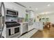 Modern kitchen featuring stainless steel appliances, white cabinets, and hardwood floors at 952 Columbia Dr, Decatur, GA 30030