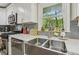 Updated kitchen with stainless steel appliances, apron sink and quartz countertops under a window at 952 Columbia Dr, Decatur, GA 30030