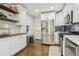 Kitchen with stainless appliances, white cabinetry, quartz countertops, and access to the backyard at 952 Columbia Dr, Decatur, GA 30030