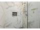 Shower featuring marble tile walls, glass enclosure, and modern fixtures for a spa-like experience at 952 Columbia Dr, Decatur, GA 30030