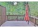 A wooden deck with an umbrella and a wooden railing overlooking a treed backyard at 1147 Laurel Valley Ct, Buford, GA 30519