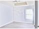 Bright bedroom features a modern light fixture, a textured wall, and a window for ample natural light at 1147 Laurel Valley Ct, Buford, GA 30519