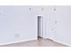 Bright room with wood-look flooring, white walls, and a doorway leading to other rooms at 1147 Laurel Valley Ct, Buford, GA 30519