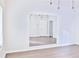 Bright bedroom features wood-look flooring, statement mirror wall, modern lighting and large window at 1147 Laurel Valley Ct, Buford, GA 30519