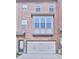 Charming brick townhome featuring an attached garage and inviting front entrance at 1147 Laurel Valley Ct, Buford, GA 30519
