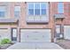 Townhome with attached garage and large front window, offering lots of natural light at 1147 Laurel Valley Ct, Buford, GA 30519