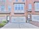 Brick townhome with an attached garage and well-maintained driveway at 1147 Laurel Valley Ct, Buford, GA 30519