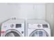 Bright laundry room features side-by-side washer and dryer at 1147 Laurel Valley Ct, Buford, GA 30519