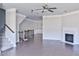 Open-concept living room with a fireplace, hardwood floors, and stairs at 1147 Laurel Valley Ct, Buford, GA 30519