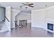 Spacious living room with a fireplace, hardwood floors, and a ceiling fan at 1147 Laurel Valley Ct, Buford, GA 30519