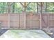 Fenced in patio with a wooden pergola and trees visible beyond the fence at 1147 Laurel Valley Ct, Buford, GA 30519