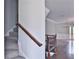 Stairs with a dark wood railing and chandelier in the background at 1147 Laurel Valley Ct, Buford, GA 30519