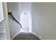 Carpeted staircase with a wooden handrail at 1147 Laurel Valley Ct, Buford, GA 30519
