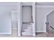 Hallway with stairs leading upstairs, and a bathroom entrance at 1147 Laurel Valley Ct, Buford, GA 30519
