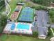 Aerial view of community amenities showcasing a pool, tennis courts, playground, and ample parking at 2130 Hollowbrooke Nw Way, Acworth, GA 30101