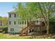 Charming backyard with deck, mature trees, stone walkway, and ample space for outdoor enjoyment at 2130 Hollowbrooke Nw Way, Acworth, GA 30101