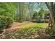 A view of the backyard showing the landscape and trees around the yard at 2130 Hollowbrooke Nw Way, Acworth, GA 30101