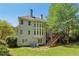 Backyard with stone patio, seating, deck with stairs, and view of the large home's windows at 2130 Hollowbrooke Nw Way, Acworth, GA 30101