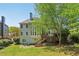 Expansive backyard view of deck, lush lawn and tall leafy trees providing shade at 2130 Hollowbrooke Nw Way, Acworth, GA 30101