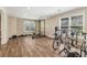 Spacious basement gym with wood floors, weight rack, and bike trainers near bright windows at 2130 Hollowbrooke Nw Way, Acworth, GA 30101