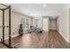 Open basement with wood flooring, weight rack, and exercise bikes near an exterior door at 2130 Hollowbrooke Nw Way, Acworth, GA 30101