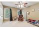 Comfortable bedroom showcasing a ceiling fan, two windows with curtains, and a twin bed at 2130 Hollowbrooke Nw Way, Acworth, GA 30101