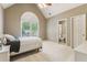 Bright bedroom with a vaulted ceiling, arched window, and a bed with white linens at 2130 Hollowbrooke Nw Way, Acworth, GA 30101