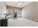 An office space with neutral walls and carpet, two windows, overhead lighting, and a black desk at 2130 Hollowbrooke Nw Way, Acworth, GA 30101