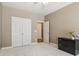 A neutral bedroom with white trim, white closet doors, and black cabinet on white carpet at 2130 Hollowbrooke Nw Way, Acworth, GA 30101