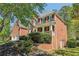 Traditional brick home with manicured landscaping and a welcoming front porch, complete with a two-car garage at 2130 Hollowbrooke Nw Way, Acworth, GA 30101