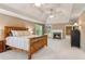 Relaxing main bedroom featuring a cozy fireplace, tray ceiling, and comfortable decor at 2130 Hollowbrooke Nw Way, Acworth, GA 30101