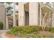 Exterior of a modern building, showcasing the front entrance, landscaped with greenery and colorful flowers at 3300 Windy Ridge Se Pkwy # 1501, Atlanta, GA 30339
