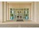 Entrance to a modern building, featuring glass doors, symmetrical planters, and a sleek, inviting design at 3300 Windy Ridge Se Pkwy # 1501, Atlanta, GA 30339