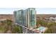 Modern high-rise building featuring a pool, balconies, and a beautiful wooded view at 3300 Windy Ridge Se Pkwy # 1501, Atlanta, GA 30339