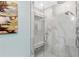 Modern walk-in shower featuring marble tile, a glass enclosure, and a built-in bench at 3300 Windy Ridge Se Pkwy # 1501, Atlanta, GA 30339