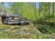 Expansive backyard featuring a two-tiered deck with views of the lush, wooded surroundings and small creek at 4812 Lismoor Sw Trce, Mableton, GA 30126